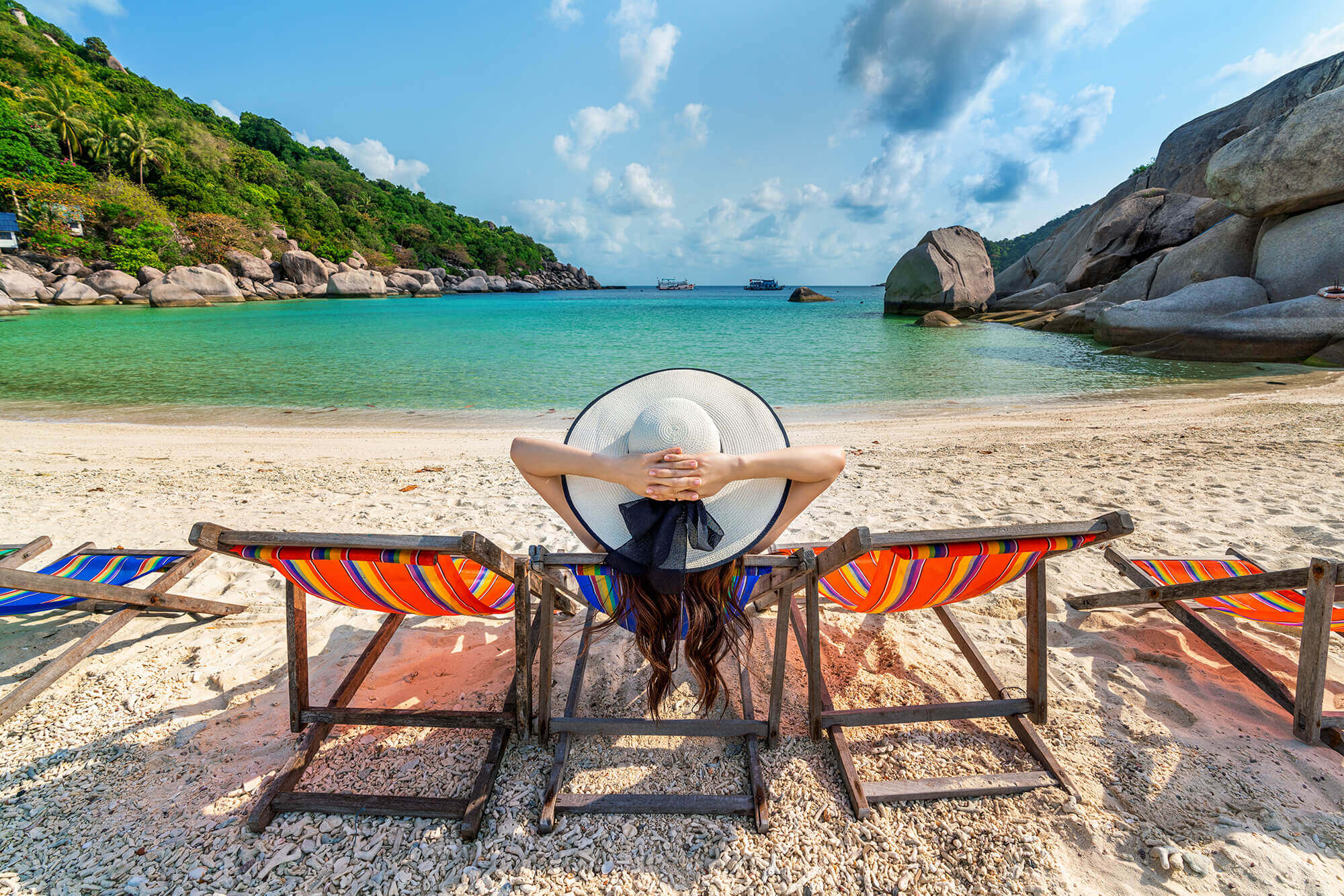 woman-with-hat-sitting-chairs-beach-beautiful